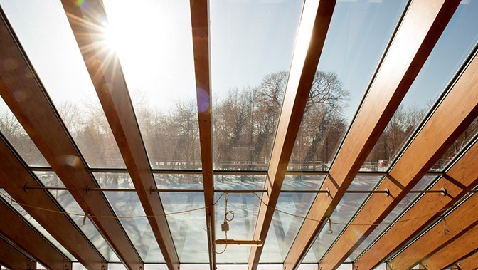 ceiling beams with glass roof and bright sky